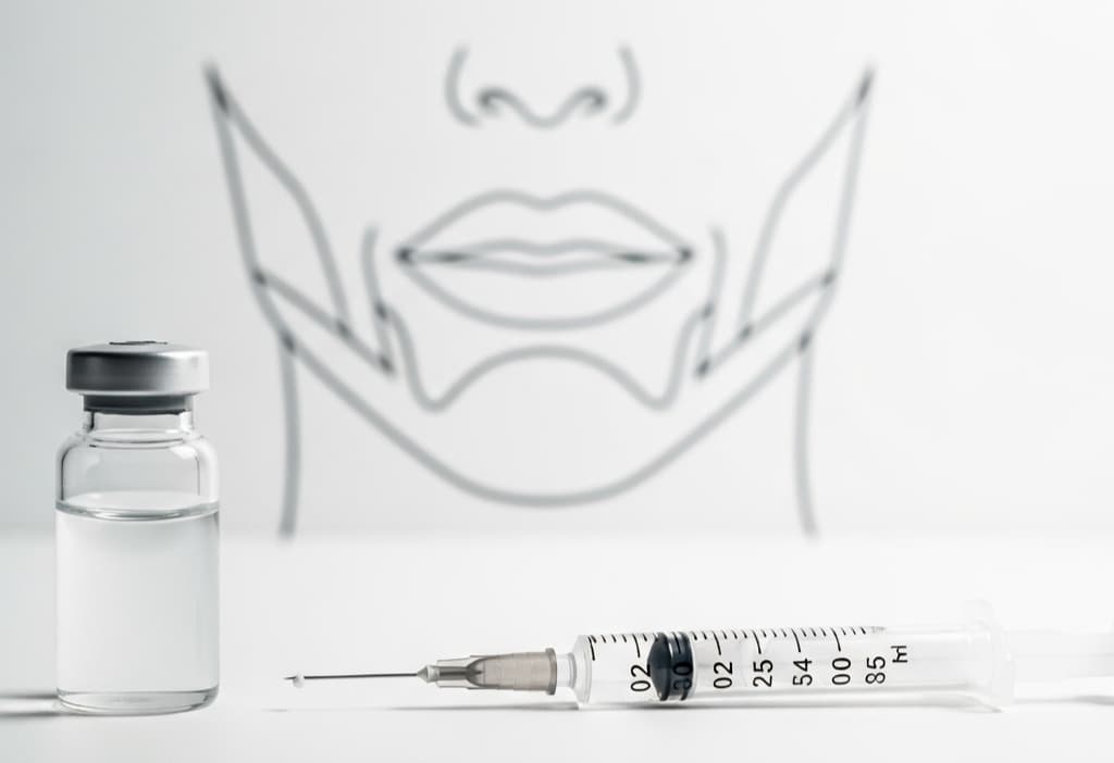 How many units of Botox for masseter concept showing Botox vial, syringe, and jawline focus